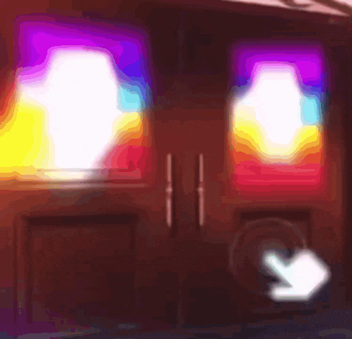 a hand pointing at a door with a rainbow of colors