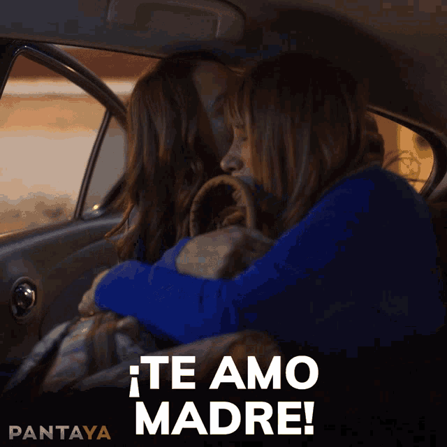 two women sitting in a car with the words te amo madre