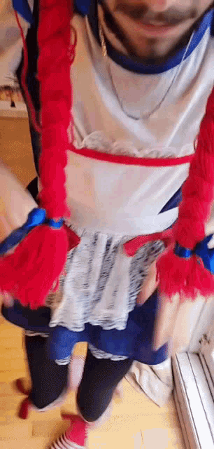 a man is dressed in a costume with red hair