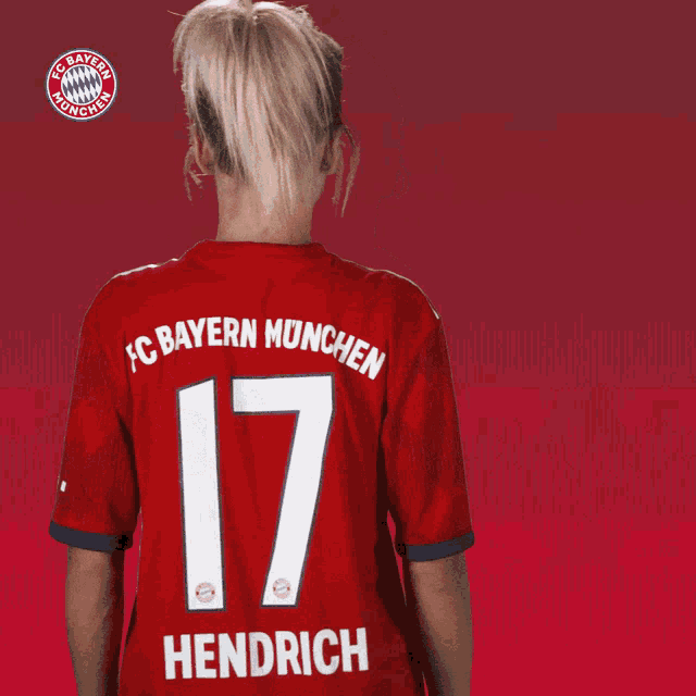 a woman with her arms crossed is wearing a bayern munchen jersey