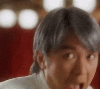 a close up of a person 's face with a surprised look on their face .