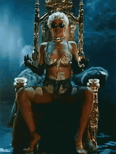 a woman is sitting on a throne with money on her bottom