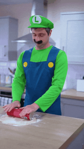 a man dressed as luigi is rolling dough