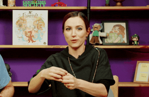 a woman in front of a shelf with a sign that says goodtime society