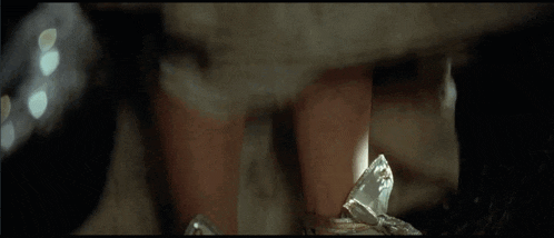 a close up of a person 's legs and a broken glass