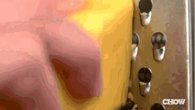 a close up of a grater with the word chow written on it