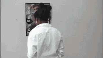 a woman is standing in front of a poster of terry rayborn