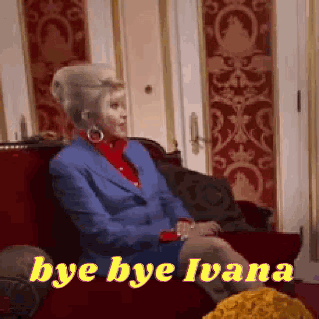 a woman in a blue suit is sitting on a red couch with the words bye bye ivana above her .