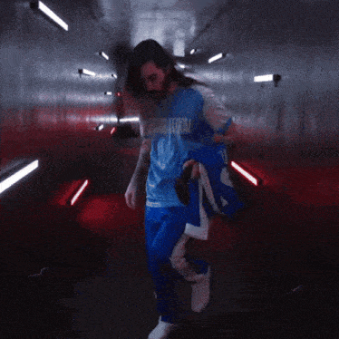 a person in a red outfit is walking through a dark tunnel