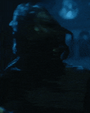 a woman is swimming in the water with her hair blowing in the wind