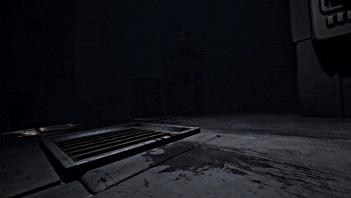 a manhole cover is open in a dark room with a sign that says ' emergency exit ' on it
