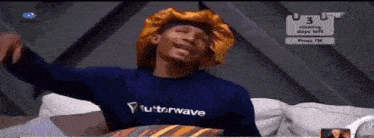 a man wearing a blue shirt with futurwave written on it