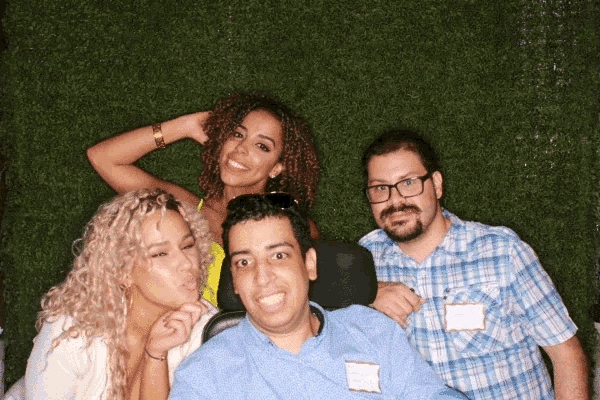 a group of people posing for a picture with one man wearing a name tag that says ' juan ' on it