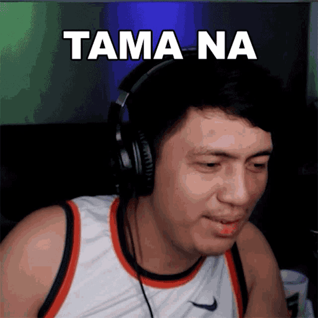 a man wearing headphones says tama na on his face