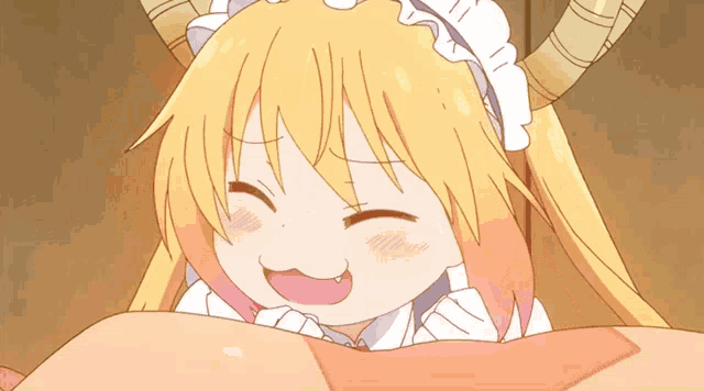 a cartoon girl with horns is laying on a person 's chest