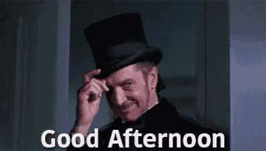 a man in a top hat is smiling and saying good afternoon .
