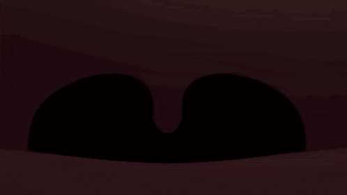 a close up of a cartoon character 's mouth with a black tongue sticking out of it .