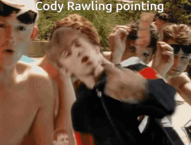a group of young men with the caption cody rawling pointing behind them