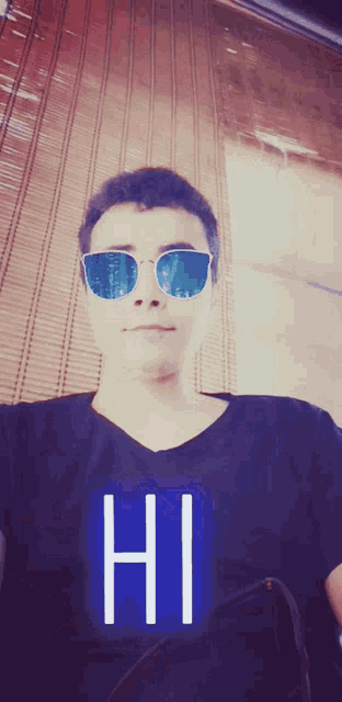a man wearing sunglasses and a shirt that has the word hi on it