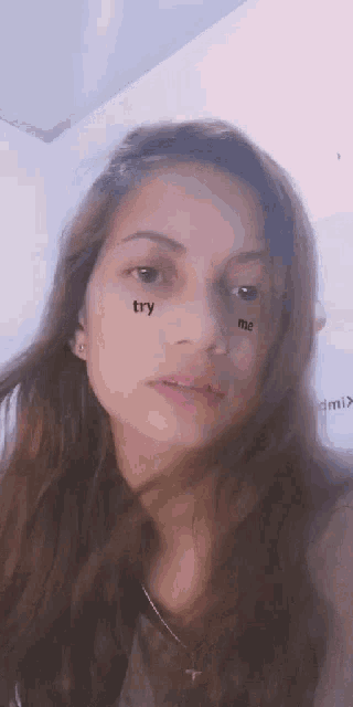 a close up of a woman 's face with the words try me on her face .