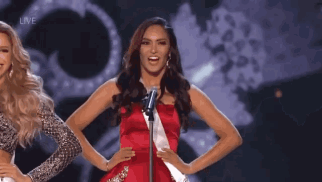a woman in a red dress is standing in front of a microphone with the word live on the bottom right