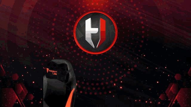 a man with a beard is sitting in front of a h logo