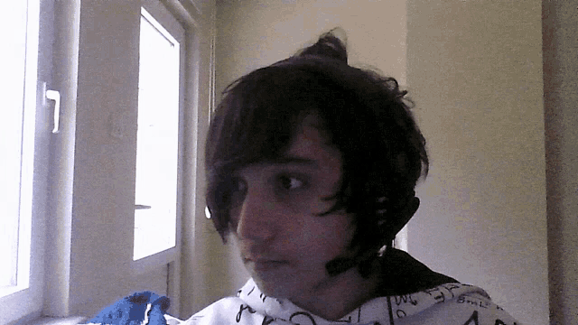 a young man wearing a headset with the letter n on it