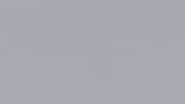a gray background with a white circle in the middle of it .