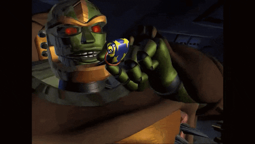 a green robot with red eyes is holding a blue object in his hand .