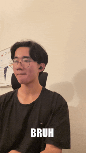 a young man wearing glasses and a black shirt with the word bruh on the bottom