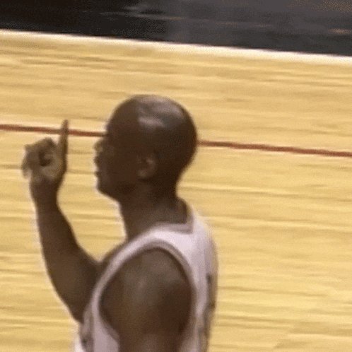 a man in a basketball uniform is giving a thumbs up sign