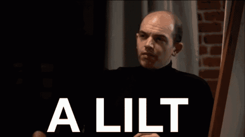 a shirtless man with a finger in his mouth and the words a lilt behind him