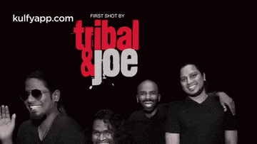 a group of men standing next to each other in front of a poster that says tribal and joe