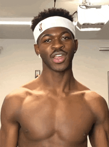 a shirtless man wearing a white headband with a nba logo on it