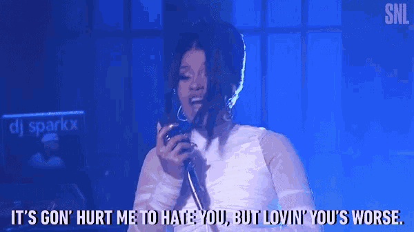 a woman is singing into a microphone and says it 's gon ' hurt me