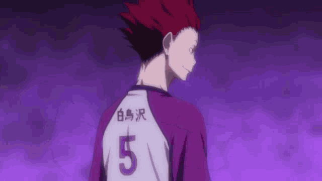 a man with red hair is wearing a purple and white shirt with the number 5 on the back .