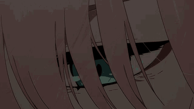 a close up of a girl 's eye with pink hair and green eyes