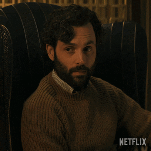 a man with a beard sits in a chair with netflix written on the bottom