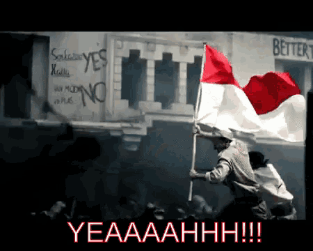a man is holding a red white and blue flag in front of a sign that says better