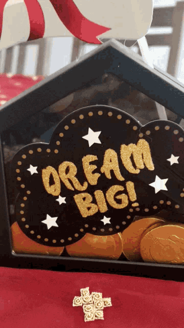 a sign that says " dream big " is surrounded by coins