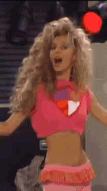 a woman with blonde hair and a pink shirt is wearing a superhero costume and making a surprised face .