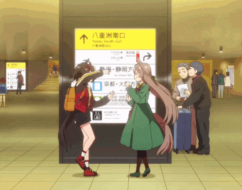 a group of people are standing in front of a yellow sign that says tsukuba train exit