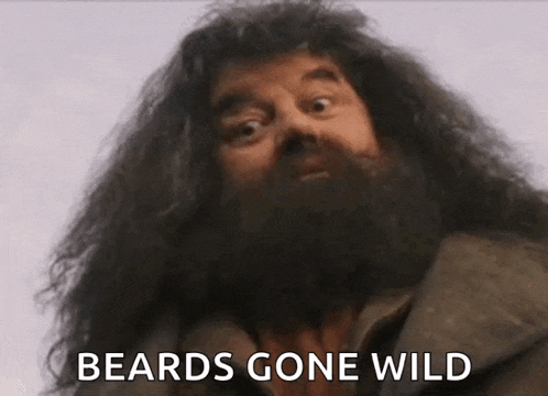 a man with a beard is making a funny face and says `` beards gone wild '' .