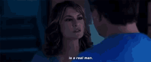 a man and a woman are looking into each other 's eyes and the woman is saying `` is a real man . ''