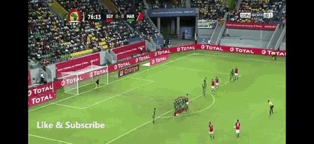a soccer game is being played in a stadium sponsored by total orange