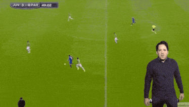 a man stands on a soccer field with the word yes behind him
