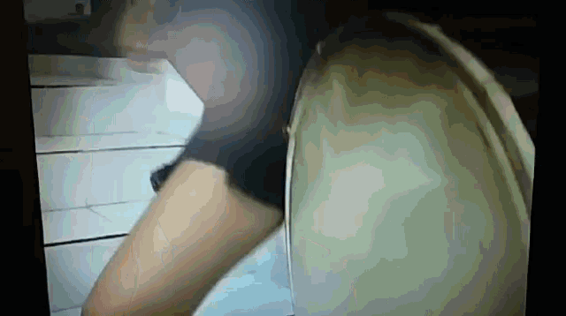 a person standing next to a toilet with a blurred background