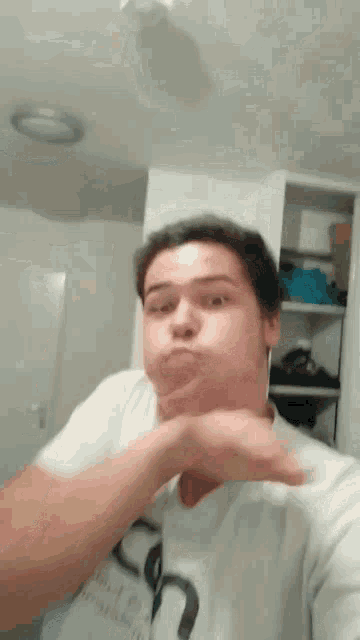 a man is making a funny face while wearing a white shirt with the letter n on it