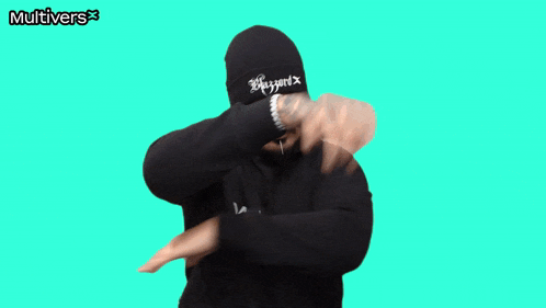 a man giving a thumbs up wearing a black multivers sweatshirt