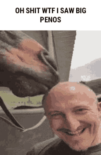 a man with a mustache is smiling while a horse licks his head .